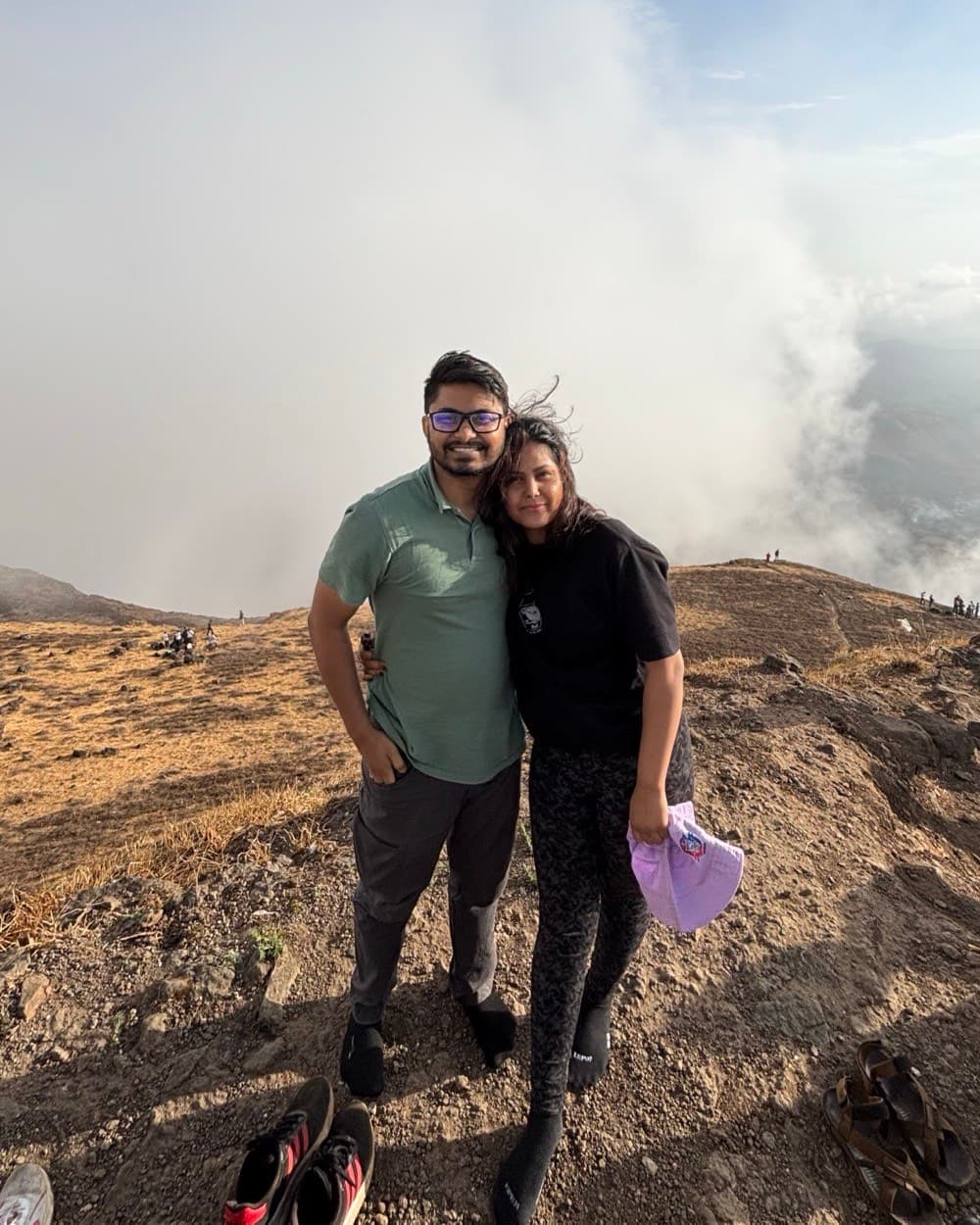 Sahil and his wife at the summit of Salher Fort, above the cloud line